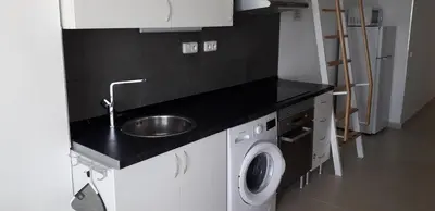 a kitchen with a sink and a washing machine at Villa SCIROCCO Madeira - Ocean View in Machico