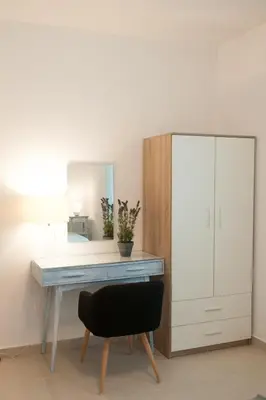a desk with a mirror and a chair in a room at Villa SCIROCCO Madeira - Ocean View in Machico