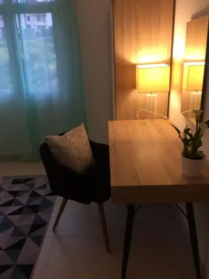 a room with a table and a chair with a lamp at Villa SCIROCCO Madeira - Ocean View in Machico