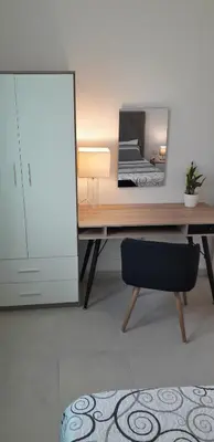 a desk with a mirror and a chair in a room at Villa SCIROCCO Madeira - Ocean View in Machico