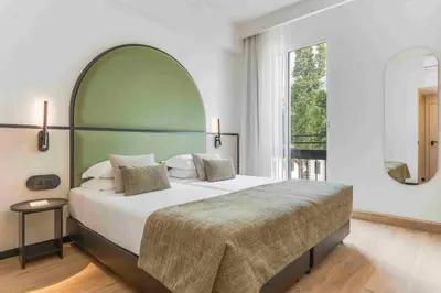 a bedroom with a large bed and a large window at The Editory Garden Carmo Funchal in Funchal