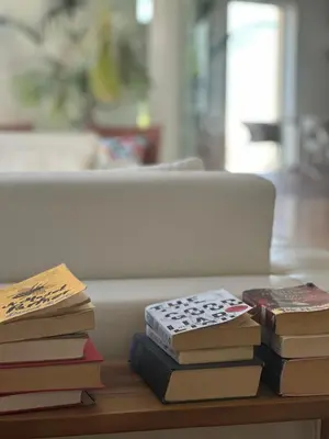 a pile of books sitting on a table at Vila Luz in Luz