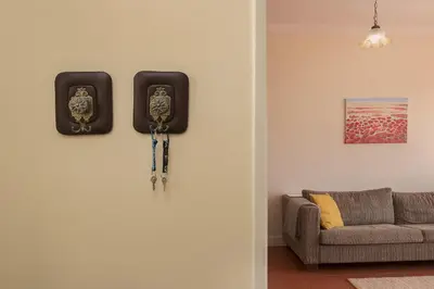 a living room with two clocks on the wall at Funchal Window by Homie in Funchal