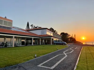 a building with a car parked in front of it at Albatroz Beach & Yacht Club in Santa Cruz