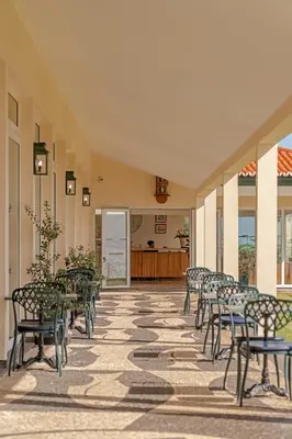 a row of chairs and tables in a building at Albatroz Beach & Yacht Club in Santa Cruz