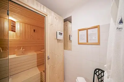 a bathroom with a shower and a toilet and a tub at Albatroz Beach & Yacht Club in Santa Cruz
