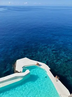 a swimming pool in the middle of the ocean at Albatroz Beach & Yacht Club in Santa Cruz