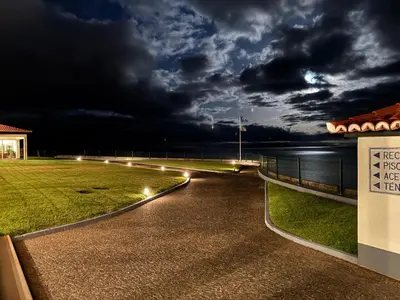 a walkway with lights on the side of a building at Albatroz Beach & Yacht Club in Santa Cruz