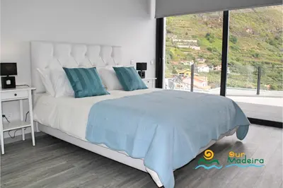 a kitchen with a dining table and chairs at OurMadeira - Calheta Charm in Calheta