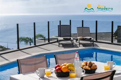 a bedroom with a large bed with a large window at OurMadeira - Calheta Charm in Calheta