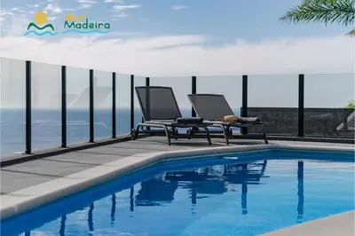 a bedroom with a bed with a view of the ocean at OurMadeira - Calheta Charm in Calheta