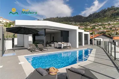 a bathroom with a sink and a toilet and a mirror at OurMadeira - Calheta Charm in Calheta