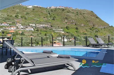 a swimming pool with a view of the ocean at OurMadeira - Calheta Charm in Calheta