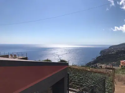 a view of the ocean from a building at Palheirinho da Achada in Arco da Calheta