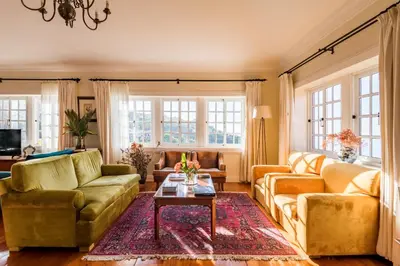a living room with two couches and a table at Villa Alto Boutique Hotel in Ponta do Sol
