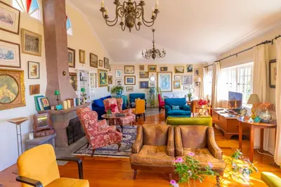 a living room filled with lots of furniture at Villa Alto Boutique Hotel in Ponta do Sol