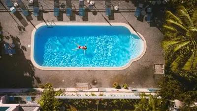 an overhead view of a person swimming in a pool at Villa Alto Boutique Hotel in Ponta do Sol