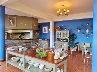 a kitchen with blue walls and a table and chairs at Villa Alto Boutique Hotel in Ponta do Sol