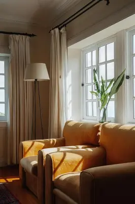 a living room with a couch and two windows at Villa Alto Boutique Hotel in Ponta do Sol