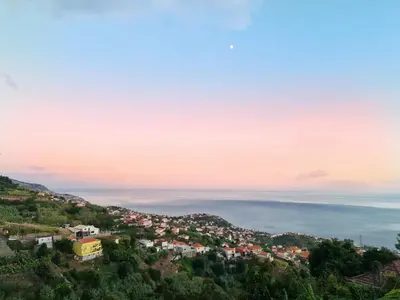 a view of a town on a hill at sunset at Villa Alto Boutique Hotel in Ponta do Sol