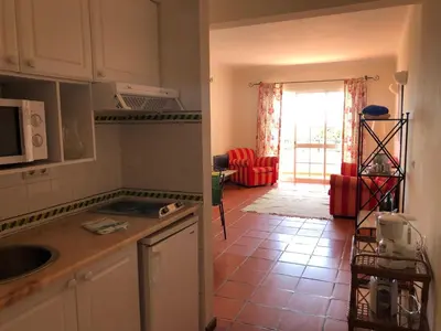 a kitchen with a view of a living room at Apartamentos Quinta Mae dos Homens in Funchal