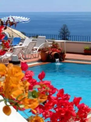 a swimming pool with red flowers on a balcony at Apartamentos Quinta Mae dos Homens in Funchal