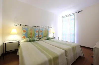 a bedroom with a large bed and a window at Apartamentos Quinta Mae dos Homens in Funchal