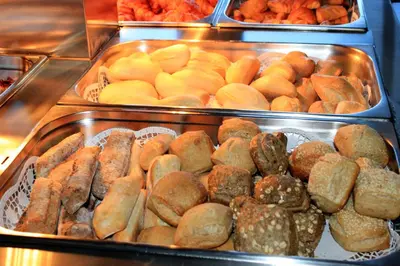 a buffet filled with lots of different types of pastries at Eira do Serrado - Hotel & Spa in Curral das Freiras