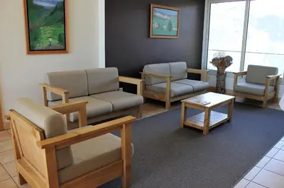 a waiting room with couches and chairs and a table at Eira do Serrado - Hotel & Spa in Curral das Freiras