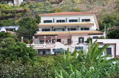 a large white house on top of a hill at Vila Marta in Funchal