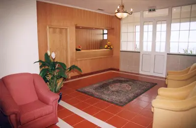 a living room with two chairs and a plant at Vila Marta in Funchal