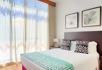 a bedroom with a bed and a large window at Hotel Torre Praia in Porto Santo