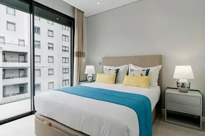a bedroom with a large bed and a large window at Funchal Lux I by An Island Apart in Funchal
