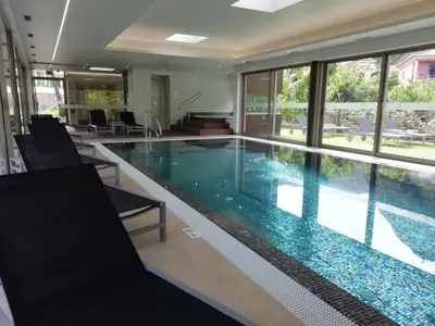 a swimming pool in a building with a large window at Solar de Boaventura in Boaventura