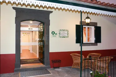 a room with a door and a table and chairs at Solar de Boaventura in Boaventura