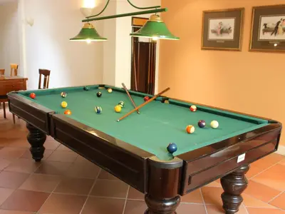 a pool table with balls on it in a room at Solar de Boaventura in Boaventura