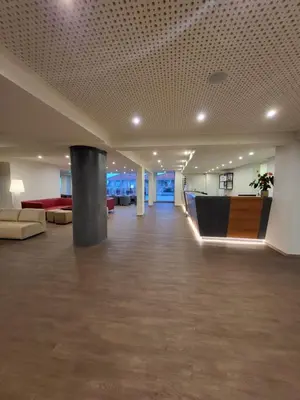 a large room with a lobby with couches and tables at Hotel Royal Orchid in Caniço