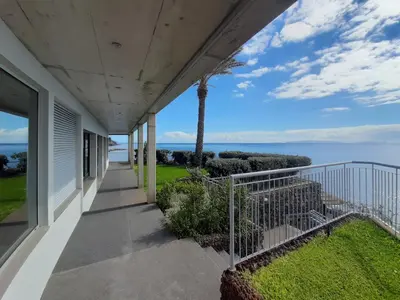 a balcony of a house with a view of the ocean at Hotel Roca Mar in Caniço