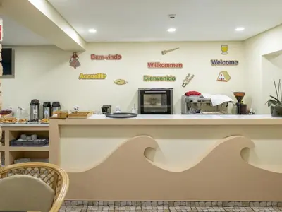 a counter in a coffee shop with signs on the wall at Zarco B&B Bed & Breakfast in Funchal