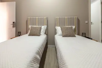 two beds sitting next to each other in a room at Zarco B&B Bed & Breakfast in Funchal