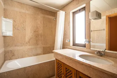 a bathroom with a sink and a tub and a mirror at Miramar Apartment with pool by Holiday Rental Madeira in Funchal