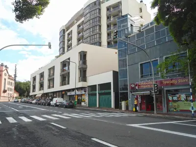 an empty city street with cars parked in front of buildings at Miramar Apartment with pool by Holiday Rental Madeira in Funchal