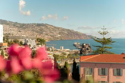 a view of a city and the ocean with buildings at Miramar Apartment with pool by Holiday Rental Madeira in Funchal