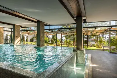 a large swimming pool in a building with a large pool at Enotel Magnólia in Funchal