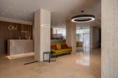 a lobby with a yellow couch and a table at Hotel Girassol - Suite Hotel in Funchal