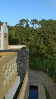 a balcony of a house with a pool of water at Colina Da Faja in Fajã da Ovelha