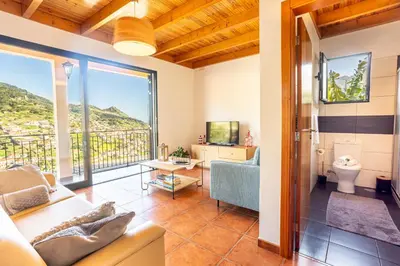 a living room with a couch and a tv at Casa Miguel in Machico