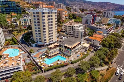an aerial view of a city with a pool and buildings at Muthu Raga Madeira Hotel in Funchal