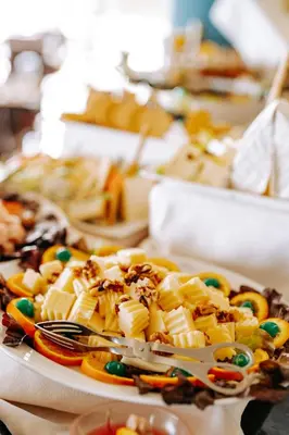 a plate of food with utensils on a table at Muthu Raga Madeira Hotel in Funchal