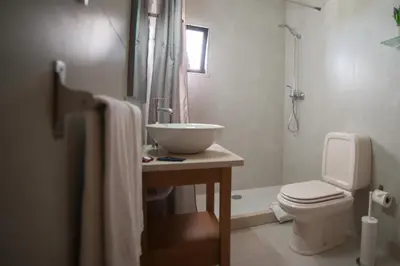 a bathroom with a sink and a toilet at Casa Rosa Montes in Luz
